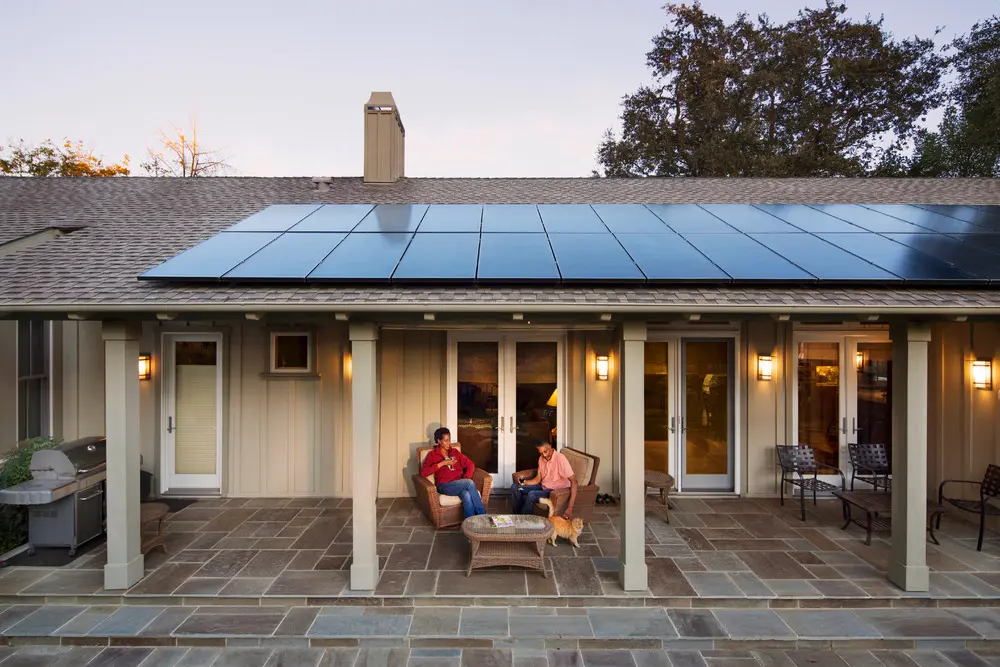 Custom home solar installation in natural woodland setting